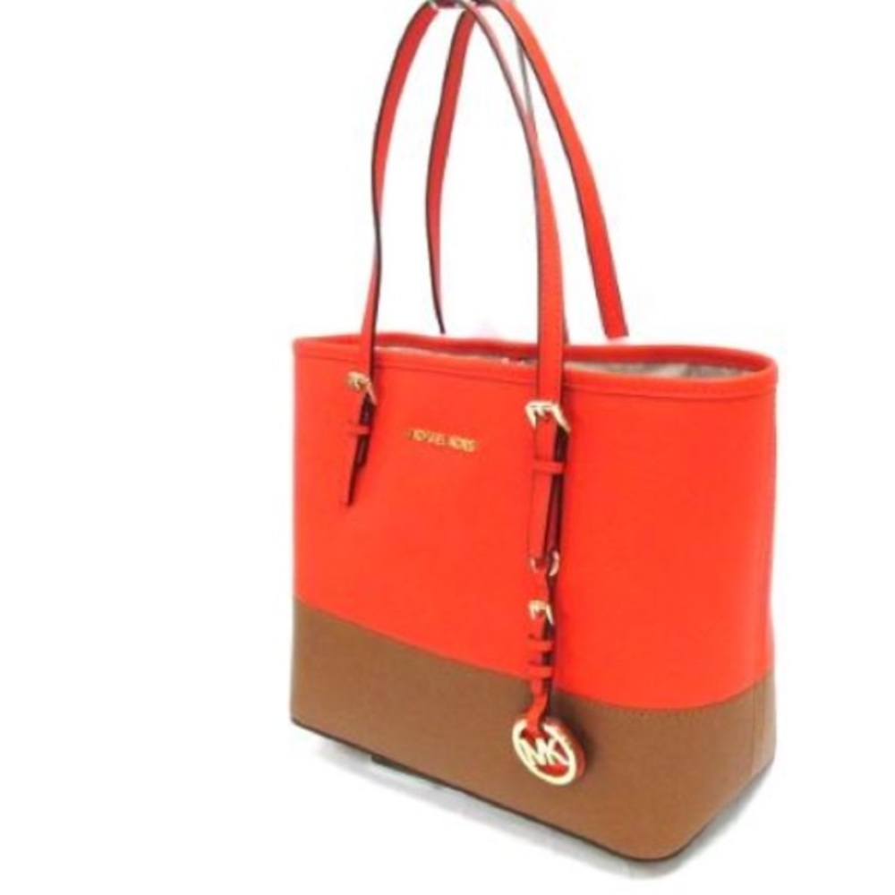 A Orange and brown Michael Kors purse